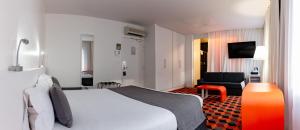 a hotel room with a bed and a chair at Best Western Hotel San Benedetto in Cholet