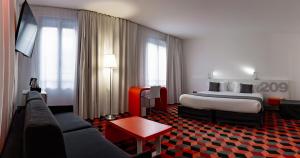 a hotel room with a bed and a couch at Best Western Hotel San Benedetto in Cholet