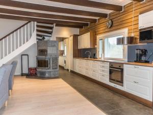 a large kitchen with white cabinets and a stove at Holiday Home Rantala by Interhome in Ranua