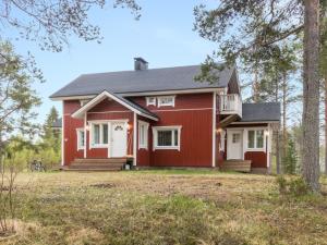 a home with a red house with a porch at Holiday Home Rantala by Interhome in Ranua