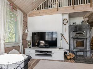 a living room with a television and a fireplace at Holiday Home Tuliniemi by Interhome in Iisalmi +17 photos