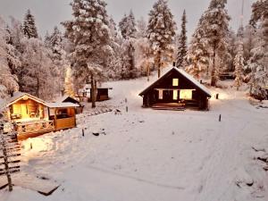 a cabin in the snow with snow covered trees at Holiday Home Vanttausranta by Interhome in Vanttauskoski +45 photos