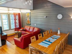 a living room with a red couch and a wooden table at Holiday Home Kelkka 2 by Interhome in Salla