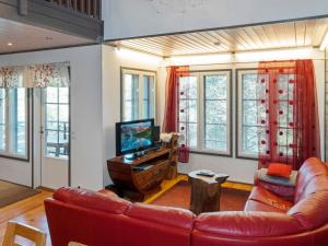 a living room with a couch and a television at Holiday Home Kelkka 2 by Interhome in Salla