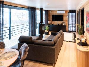 a living room with a couch and a television at Holiday Home Saanan lumous by Interhome in Kilpisjärvi
