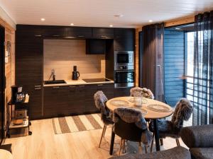 a kitchen with a table and chairs in a room at Holiday Home Saanan lumous by Interhome in Kilpisjärvi
