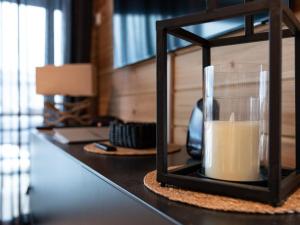 a candle in a glass on a table at Holiday Home Saanan lumous by Interhome in Kilpisjärvi
