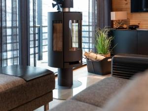 a living room with a couch and a table at Holiday Home Saanan lumous by Interhome in Kilpisjärvi +16 photos