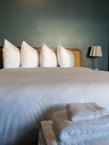 a bedroom with a bed with white pillows at Hotel Alexander in Mankato