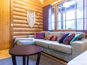 a living room with a couch and a table at Holiday Home Pyhäkolo by Interhome in Pyhätunturi