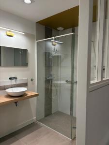 a bathroom with a glass shower and a sink at Villa Le Rubis in Agon-Coutainville +37 photos