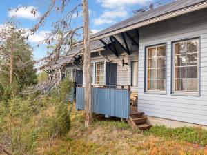 a house with a porch and a yard at Holiday Home Siulapalkinen a 4 by Interhome in Saariselka