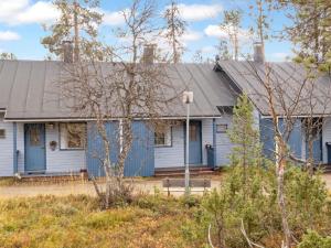 a blue house with a gray roof at Holiday Home Siulapalkinen a 4 by Interhome in Saariselka
