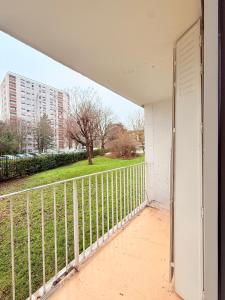 an open door to a balcony with a fence at Positive country in Aulnay-sous-Bois