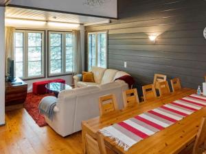 a living room with a couch and a table at Holiday Home Kelkka 1 by Interhome in Salla