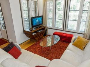 a living room with a white couch and a tv at Holiday Home Kelkka 1 by Interhome in Salla