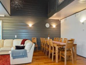 a living room with a table and a white couch at Holiday Home Kelkka 1 by Interhome in Salla +19 photos