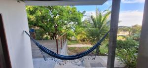 a hammock in a room with a view at Mirante Rota do Mar in Maceió