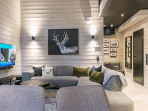 a living room with a couch and a tv at Holiday Home Villa arcus a by Interhome in Pelkosenniemi +24 photos