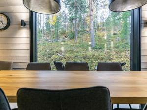 a conference room with a table and chairs and a window at Holiday Home Villa arcus a by Interhome in Pelkosenniemi