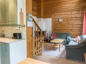 a kitchen and living room in a log cabin at Holiday Home Kranni 2 by Interhome in Syöte