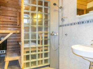 a bathroom with a glass walled shower and a sink at Holiday Home Kranni 2 by Interhome in Syöte