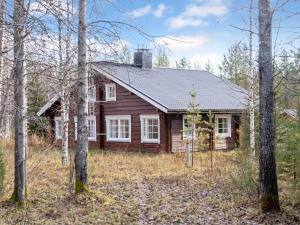a log cabin in the woods with trees at Holiday Home Kranni 2 by Interhome in Syöte