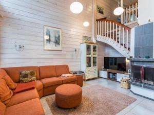 a living room with a couch and a tv at Holiday Home Otsonherra by Interhome in Pyhätunturi