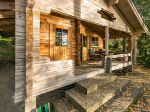 a log cabin with steps to the front porch at Holiday Home Lossitupa by Interhome in Iitti