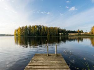 a bird sitting on a dock on a lake at Holiday Home Lossitupa by Interhome in Iitti