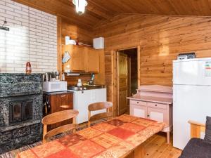 a kitchen with a table and a refrigerator at Holiday Home Lossitupa by Interhome in Iitti +10 photos