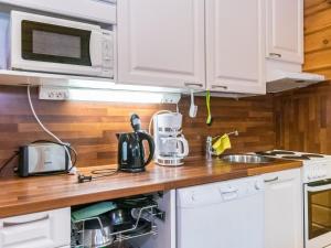 a kitchen with white cabinets and a counter top at Holiday Home Pyhä-vuonelo by Interhome in Pyhätunturi