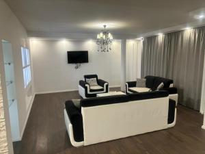 a living room with two couches and a tv at Apartmen Emina in SJJ +4 photos
