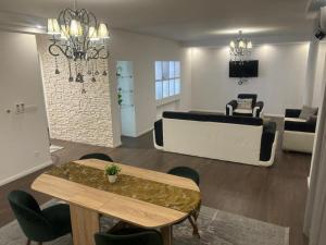 a living room with a table and a couch at Apartmen Emina in SJJ