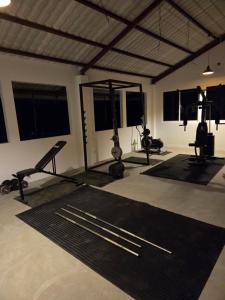 a gym with several exercise equipment in a room at Ceylon Lodge - Airport Transit Hostel in Negombo