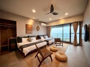 a bedroom with a large bed and a balcony at Zenith Retreat in Xiaoliuqiu