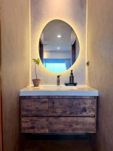 a bathroom with a sink and a mirror at Zenith Retreat in Xiaoliuqiu +63 photos