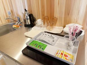 a kitchen counter with a tray of items on it at なごらーれ放生津屋 in Shimminato +87 photos