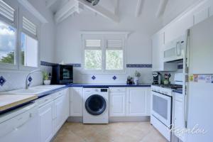 a kitchen with white cabinets and a dishwasher at Villa Kazalou in Saint Martin +11 photos