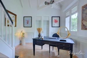 a black desk in a room with a staircase at Villa Kazalou in Saint Martin
