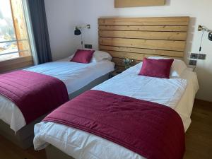 two beds sitting next to each other in a room at Luxury 2 Bedroom Apartment with view of Mont Blanc in Combloux +36 photos