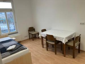 a room with a table and chairs and a bed at Hotel Lahnblick in Weilburg
