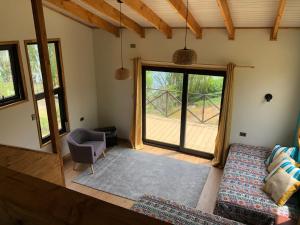 a living room with a couch and a window at Cabañas Don Lino in Cochrane