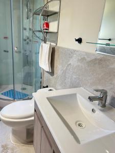 a bathroom with a sink and a toilet and a shower at Cabañas Don Lino in Cochrane +60 photos