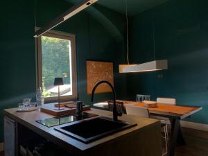 a kitchen with a sink and a table with a window at cascina lago in Montorfano