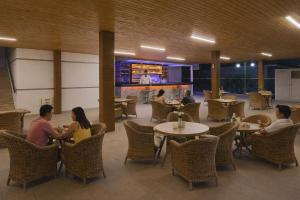 a group of people sitting at tables in a restaurant at Oji Beach Hotel in Hacılar