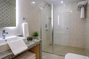a bathroom with a shower and a sink at Oji Beach Hotel in Hacılar