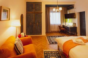 a hotel room with a bed and a couch and a desk at Art Boutique Residence - City Center - Calea Victoriei in Bucharest