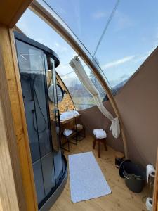 a room with a glass door and a table and chairs at Wigwam Bel'Etoile in Bellencombre