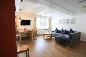 a living room with a couch and a table at Brand New, 5min to Ski PARADISE ! in Grindelwald